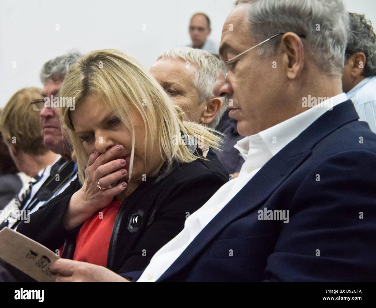 Prime Minister BENJAMIN NETANYAHU and wife SARAH NETANYAHU browse through the evening's program as they attend son's high school graduation ceremony. Jerusalem, Israel. 9-June-2013.  Prime Minister Benjamin Netanyahu and wife Sarah Netanyahu attends son's high school graduation ceremony. Stock Photo