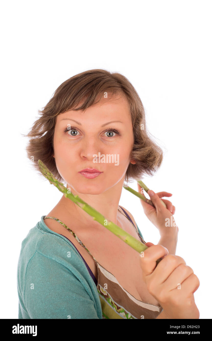 Portrait of naughty woman holding fresh green asparagus. Isolated on white background. Stock Photo