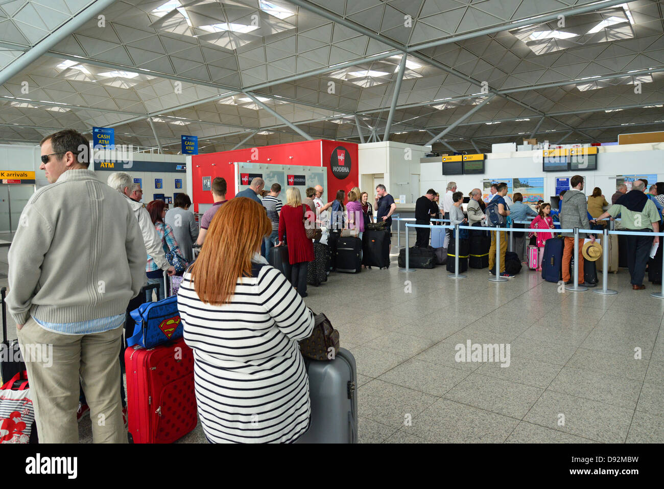 Queue at check-in desk in departure terminal, Stansted Airport, Stansted Mountfitchet, Essex, England, United Kingdom Stock Photo