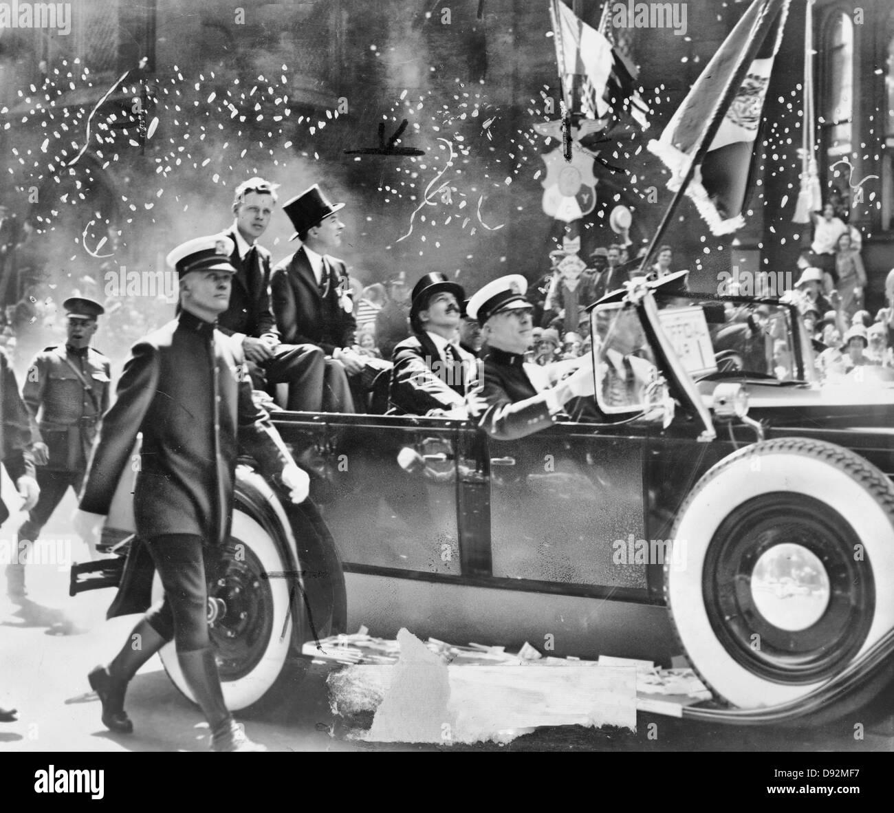Colonel Charles A. Lindbergh rode up lower Broadway in an open car next to Mayor James J. Walker, Grover Whalen is in front of the Mayor, 1927 Stock Photo