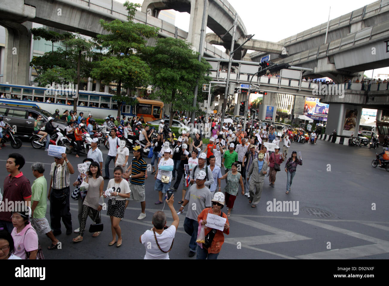 Bangkok , Thailand. 9th June 2013. About 400 of Guy Falkes white mask during rally passing through pathumwan junction to The Bangkok Art and Culture Centre. Protesters wearing "Guy Fawkes" continue to rally in Bangkok and others parts of Thailand against the Yingluck Shinawatra government, which opponents say is a "puppet" regime controlled by fugitive former premier Thaksin Shinawatra. Credit:  John Vincent/17�Թ����� Live News Stock Photo