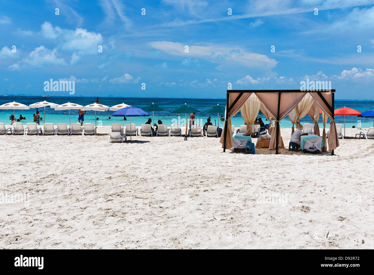 Massage Booths Lounge Chairs and Umbrellas on Playa Norte, Isla Mujeres, Mexico Stock Photo