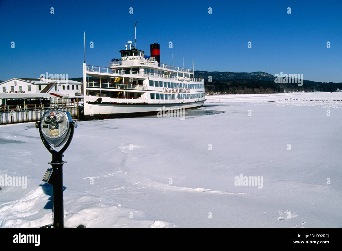 Sightseeing Boat Moored at a Pier in a Frozen Lake, Lake George Village, New York Stock Photo