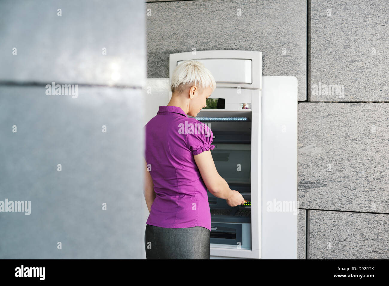 business woman withdrawing cash at bank atm Stock Photo