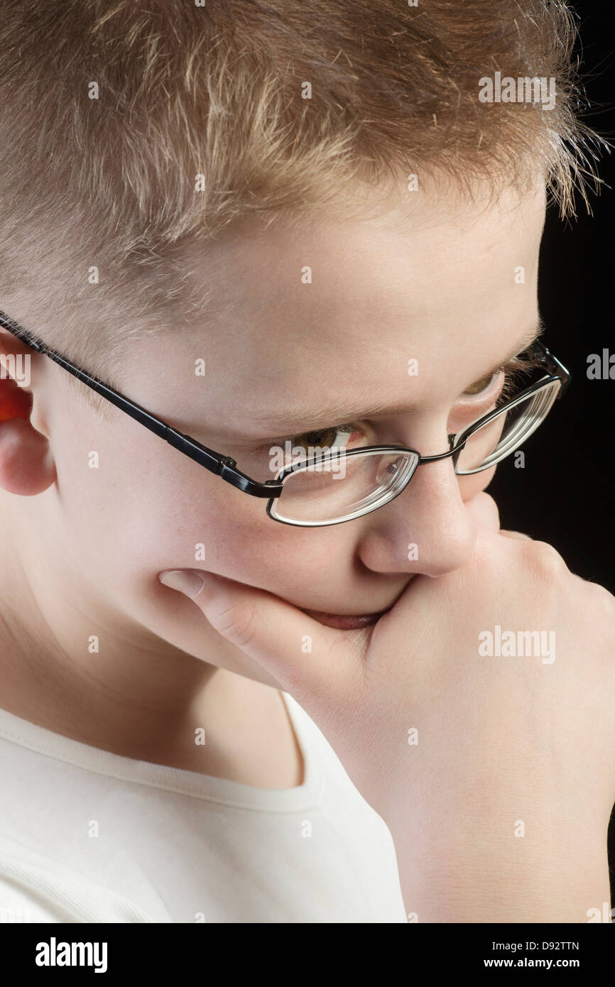 Pensive boy with hand on chin Stock Photo