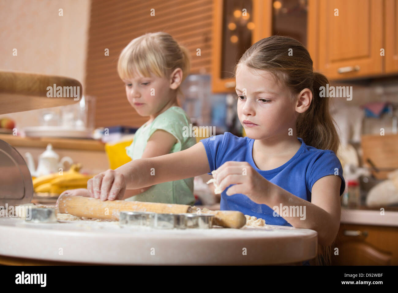 Two girls using baking dough Stock Photo