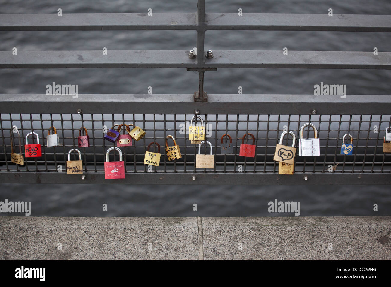 Love padlocks hanging in a row on a bridge railing in Berlin, Germany