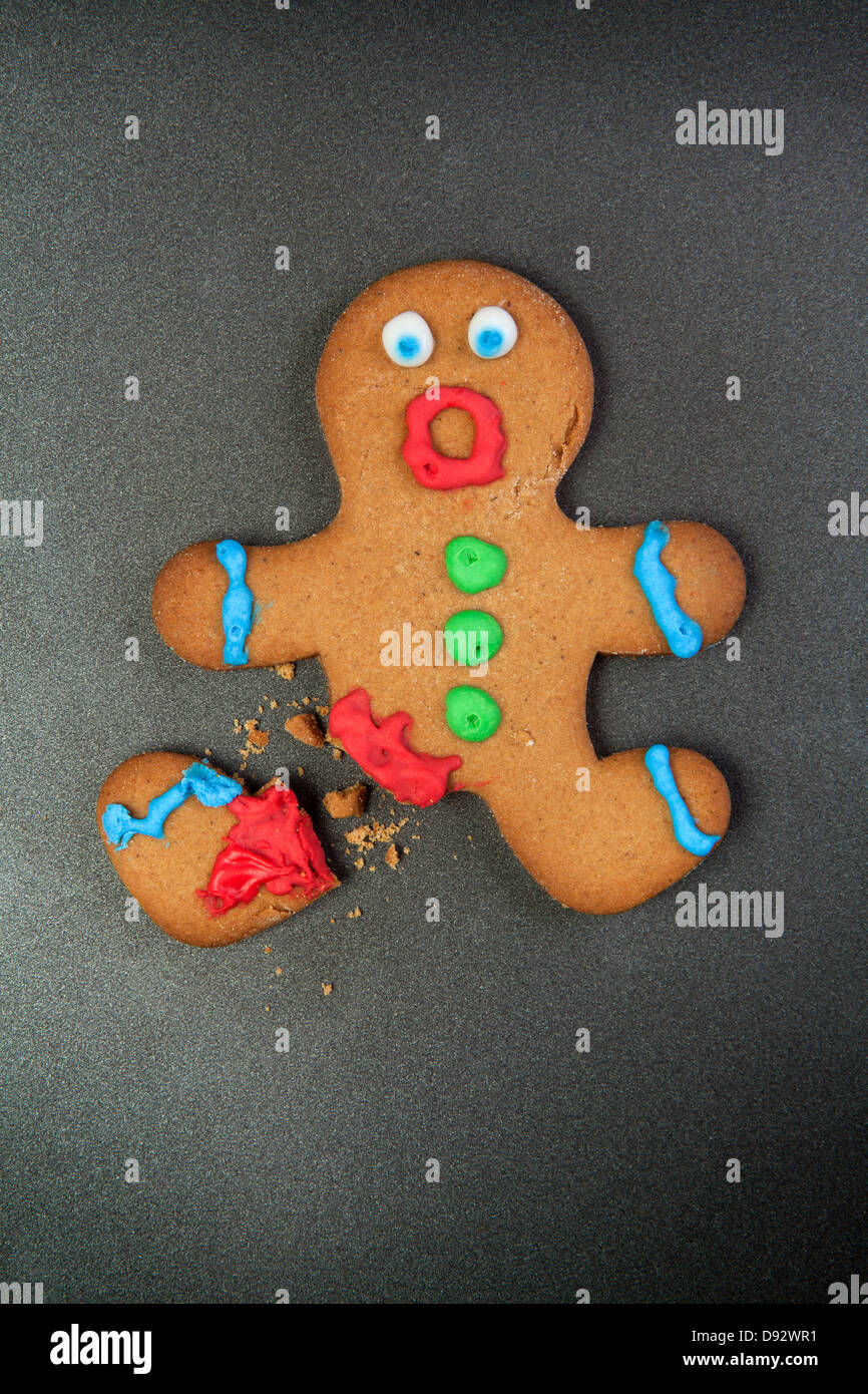 A gingerbread man looking shocked with a broken leg Stock Photo