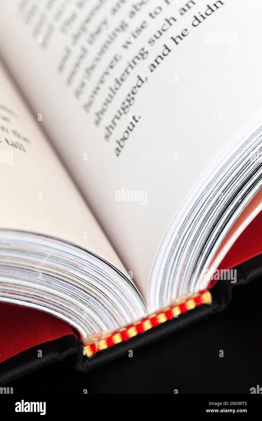 Text in an open hardcover book, close-up Stock Photo