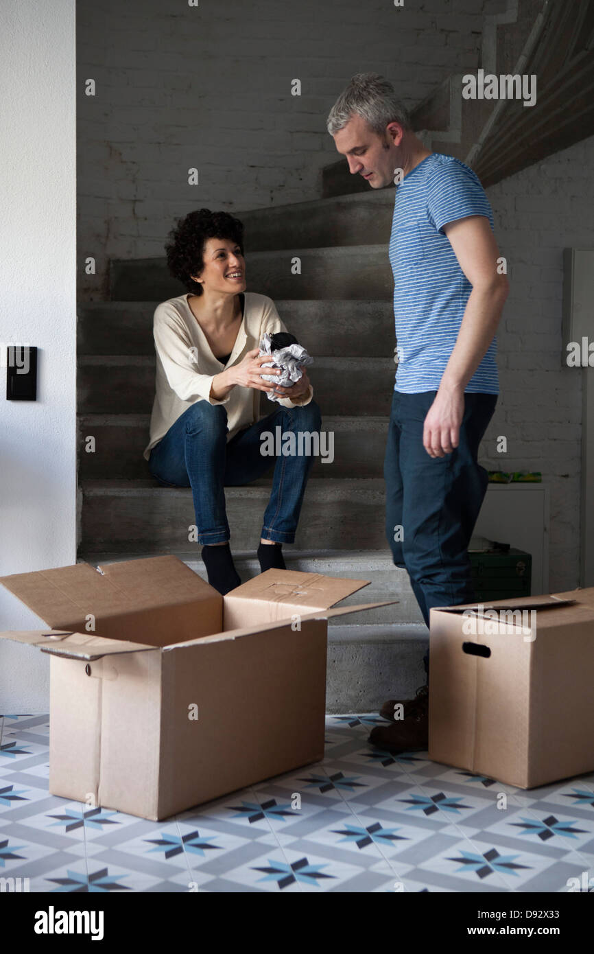 A mixed age couple packing moving boxes Stock Photo