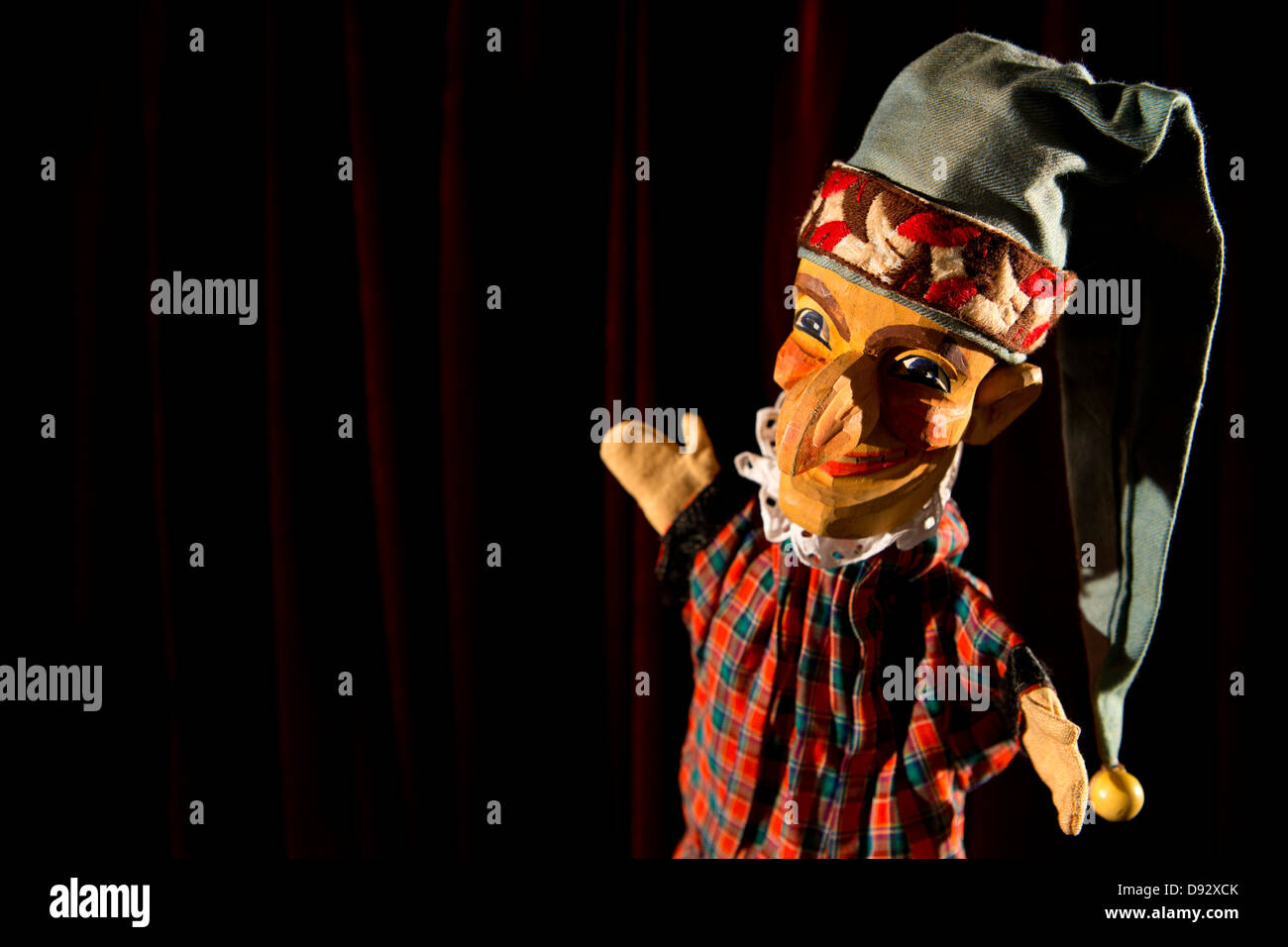 Punch from the puppet show Punch and Judy on stage smiling proudly