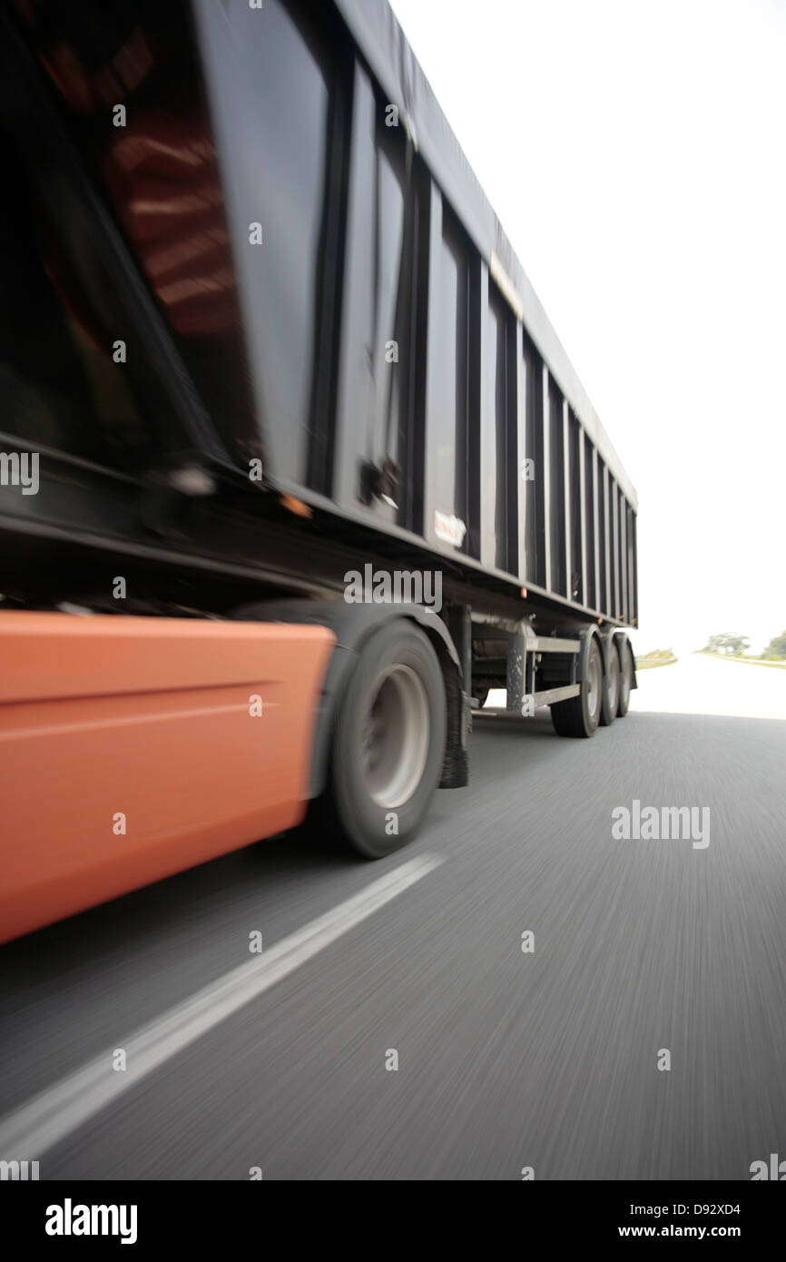 A semi-truck on a multiple lane highway Stock Photo