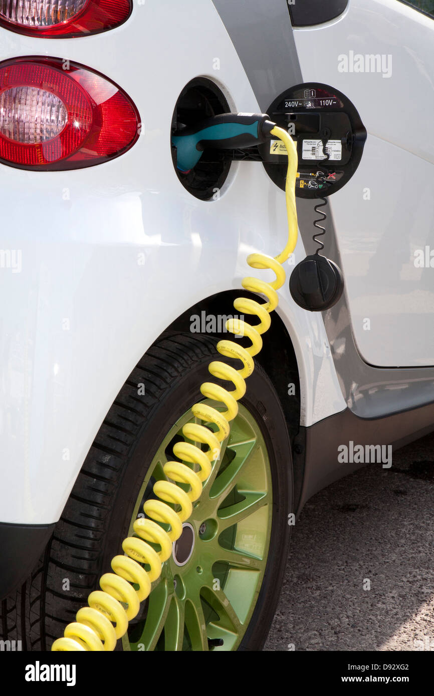 Detail of a charger connected to an electric car recharging Stock Photo