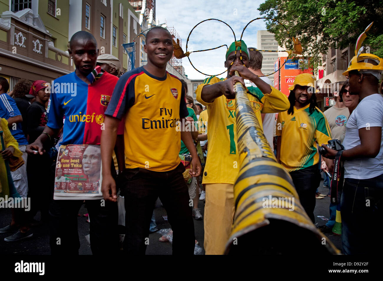 Football fans in Long Street during FIFA world cup final draw festivities in Cape Town South Africa One wears oversized glasses Stock Photo