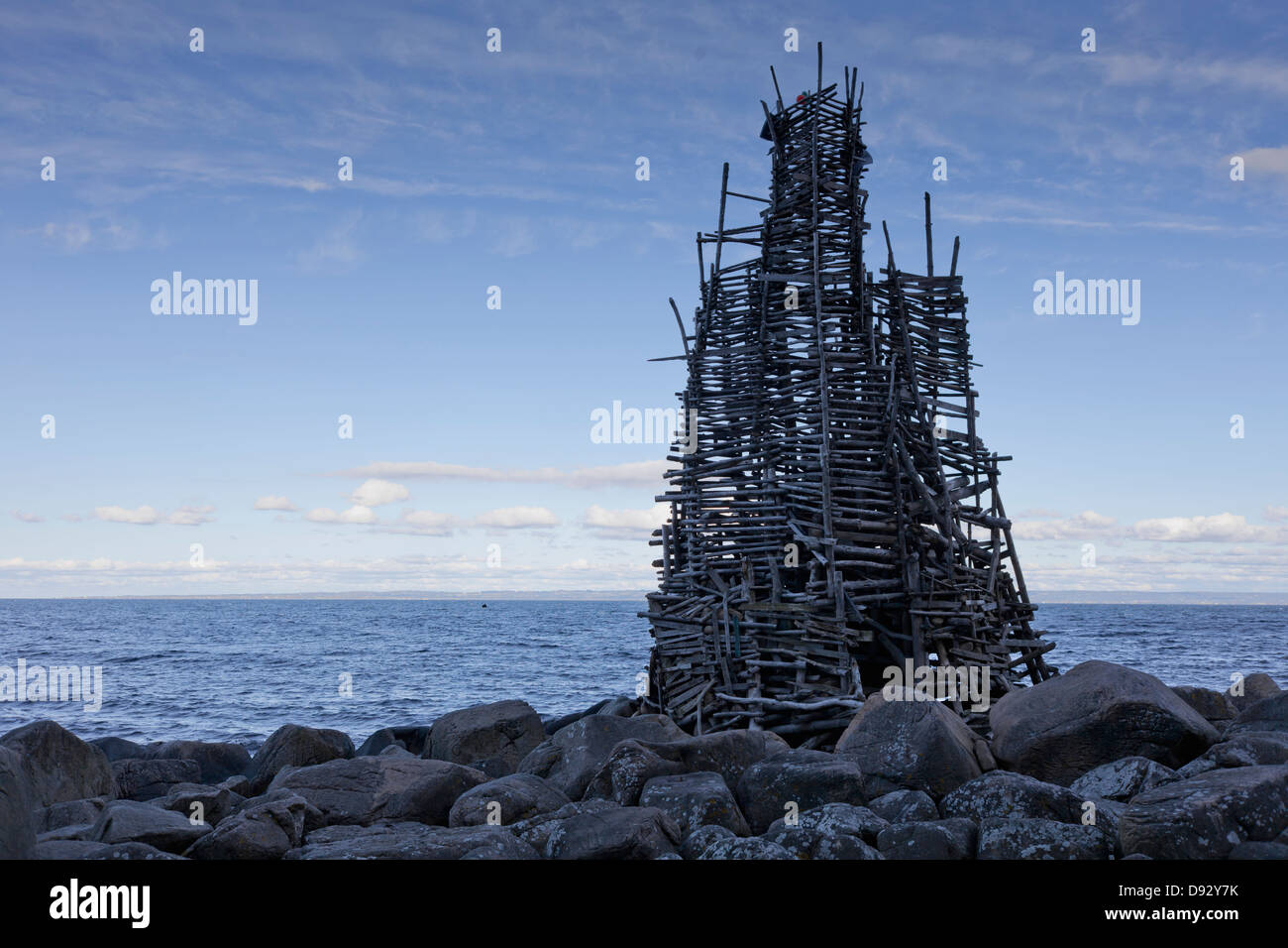 Wooden construction 'Nimis' on rocky beach Stock Photo
