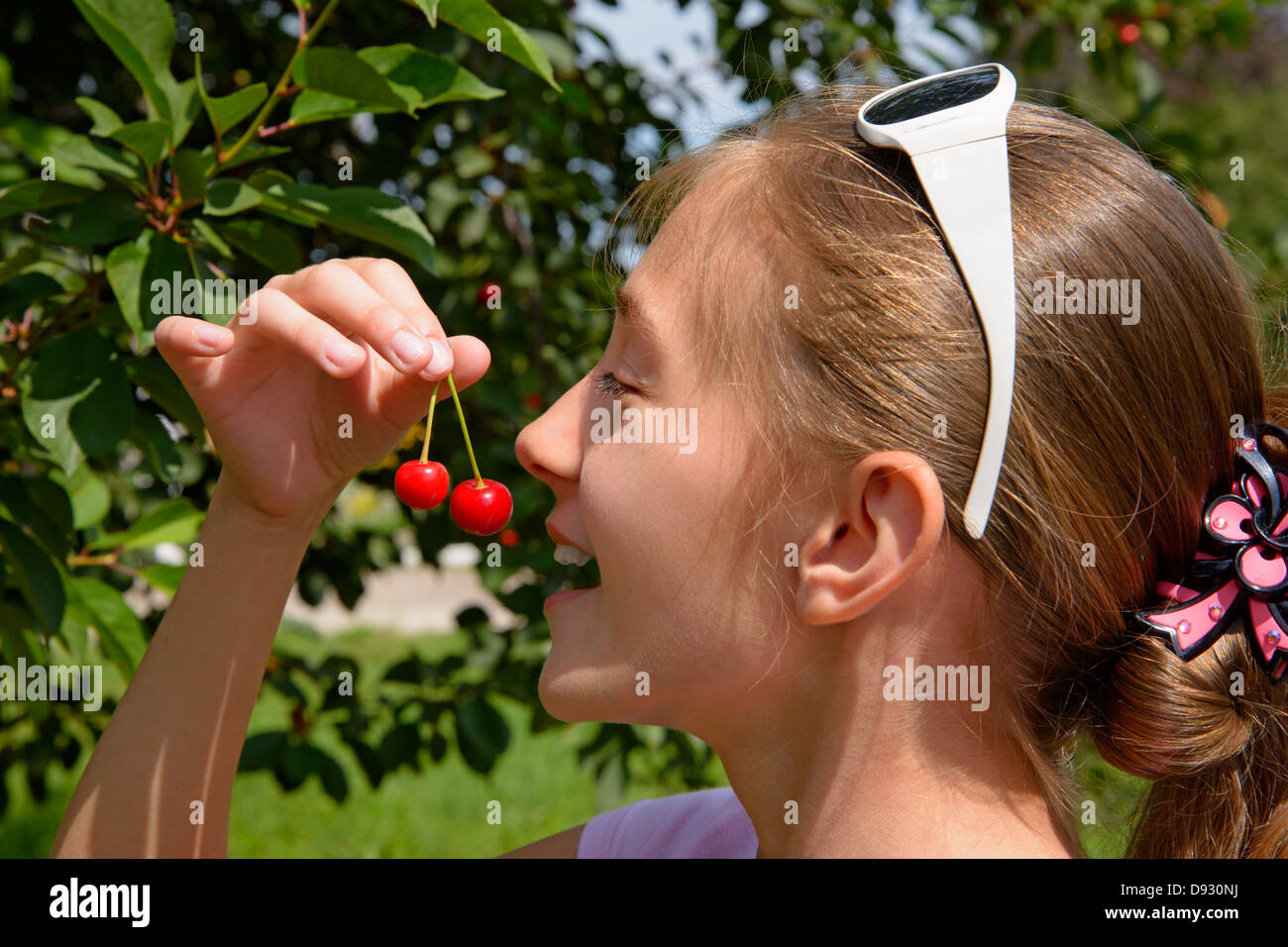 Girl eats cherry Stock Photo