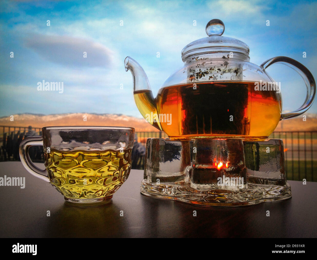 Teapot and cup on table outdoors - Smartphone Captured Stock Image