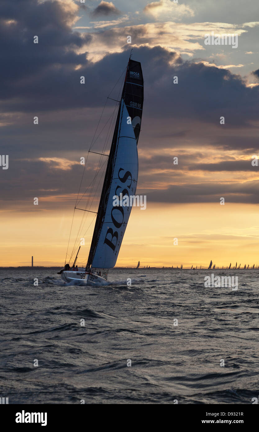 Alex Thomson Racing an Open 60 monohull in a Farr-designed race boat at sunrise Stock Photo