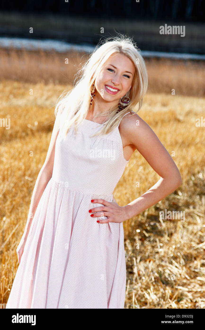 Young woman smiling dress hi-res stock photography and images - Alamy