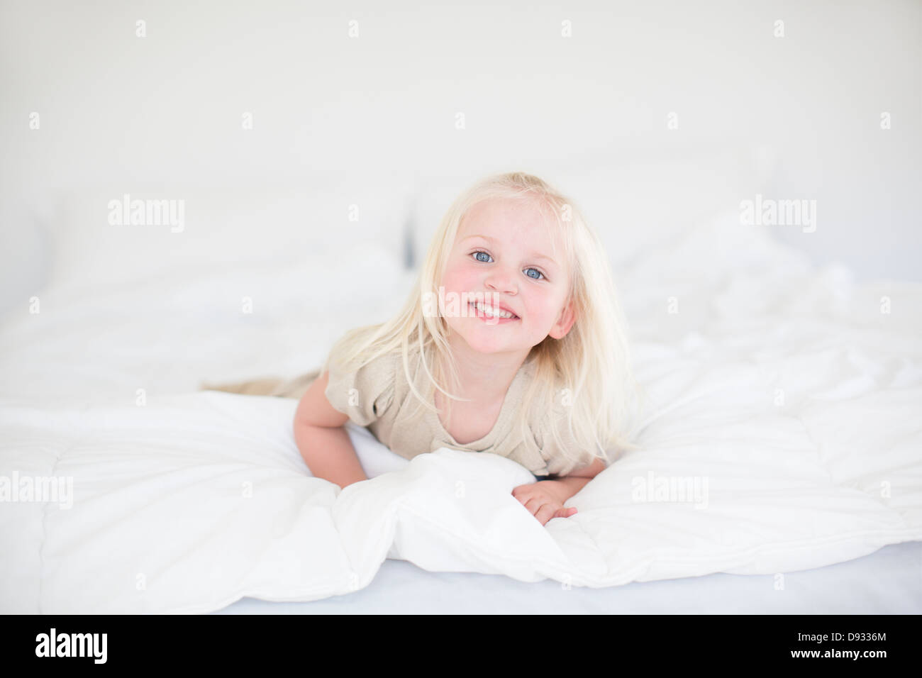 Little girl lying on bed Stock Photo Alamy