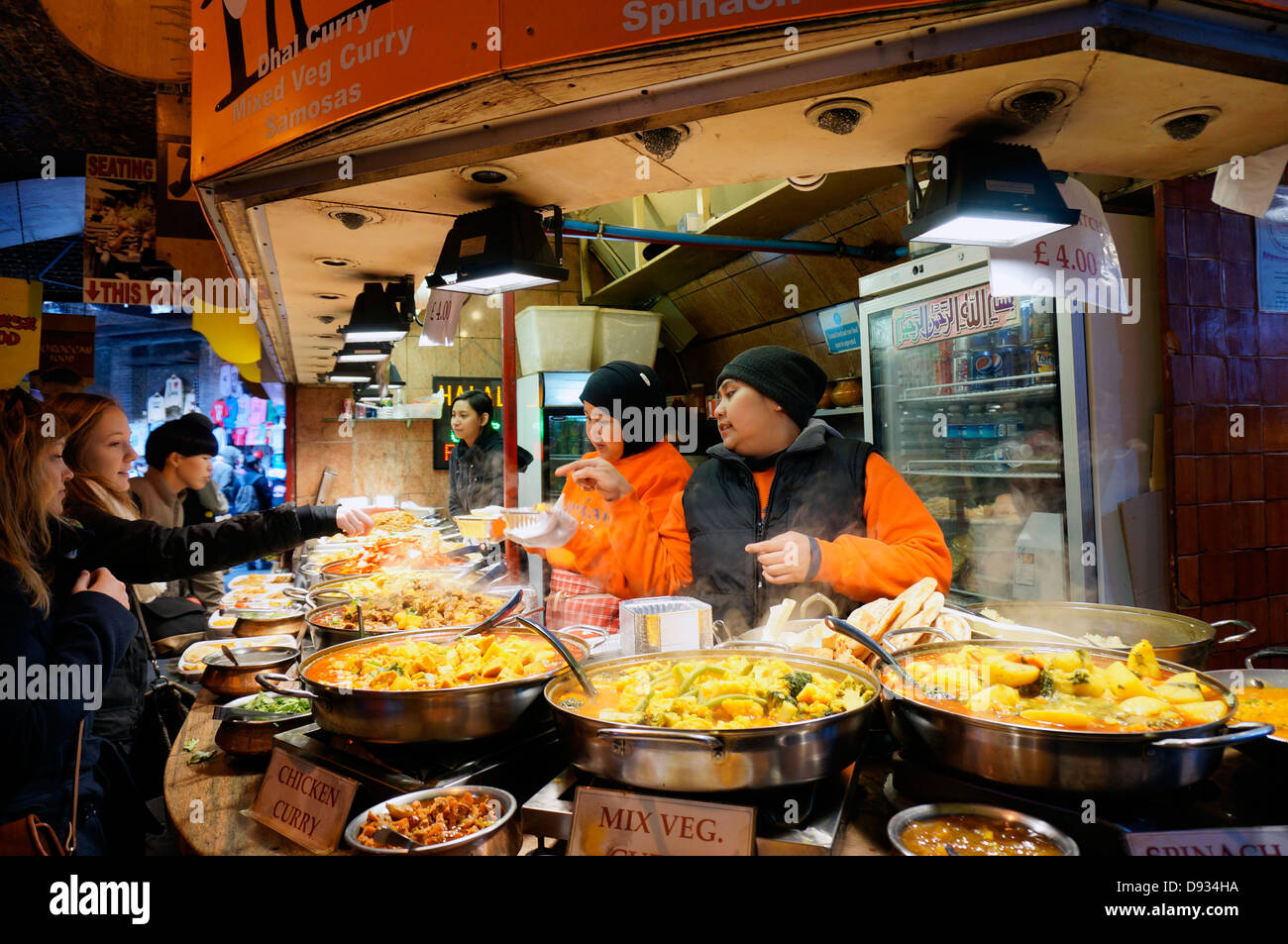 Customers being served at an Indian curry fast food stall at Camden Market, London, England, UK. Stock Photo