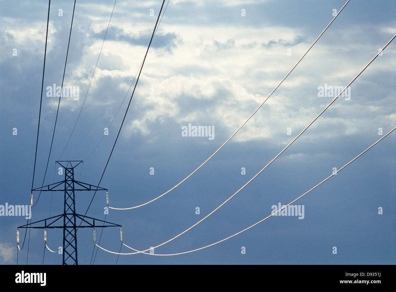 Power line against a cloudy sky Stock Photo - Alamy