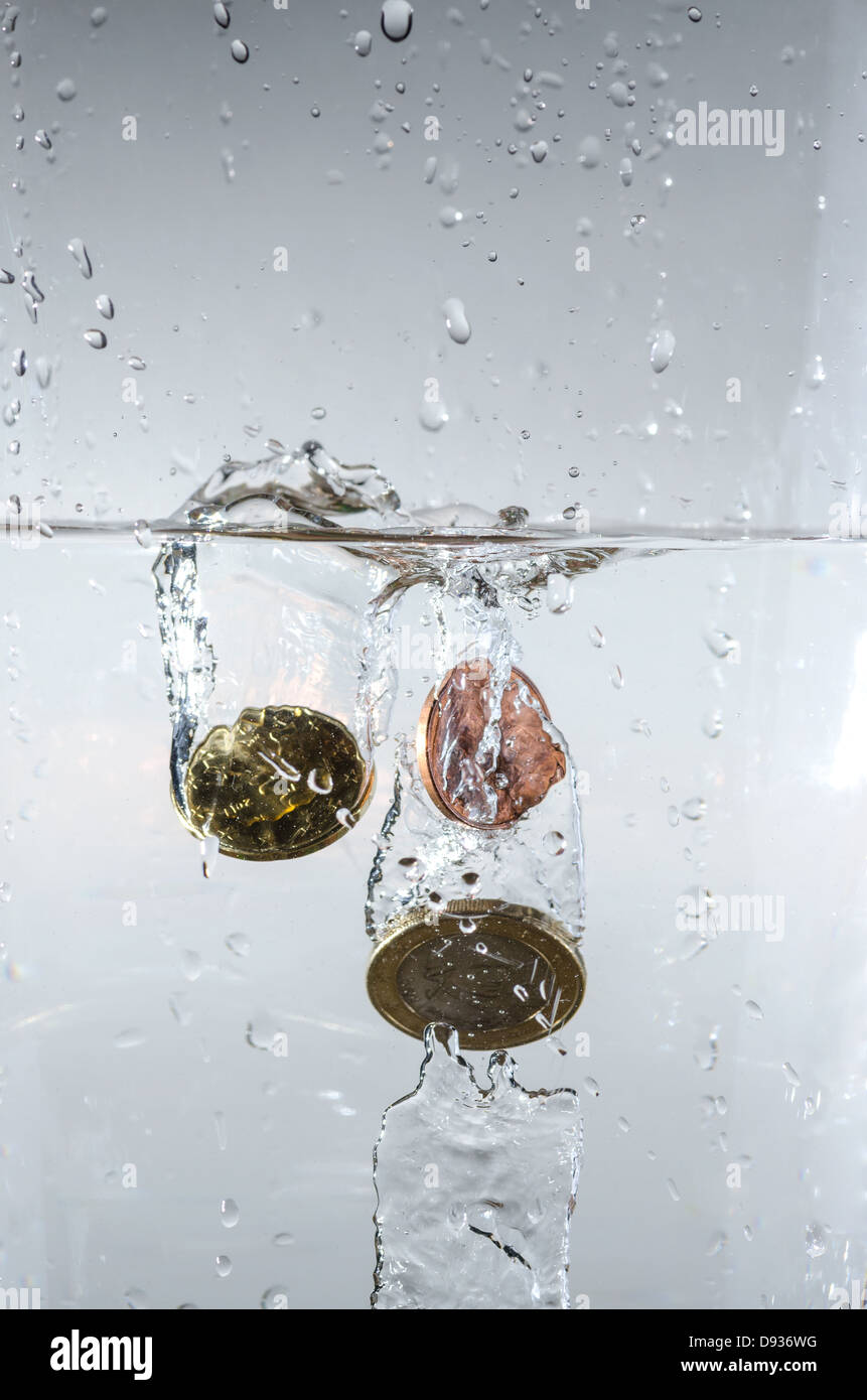 just dropping coins into the water Stock Photo Alamy