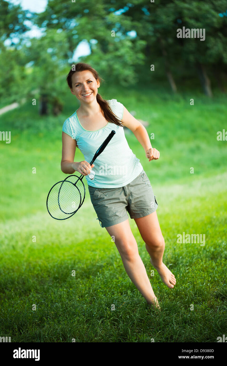 Happy, smiling girl with a racket for a badminton in the park Stock Photo