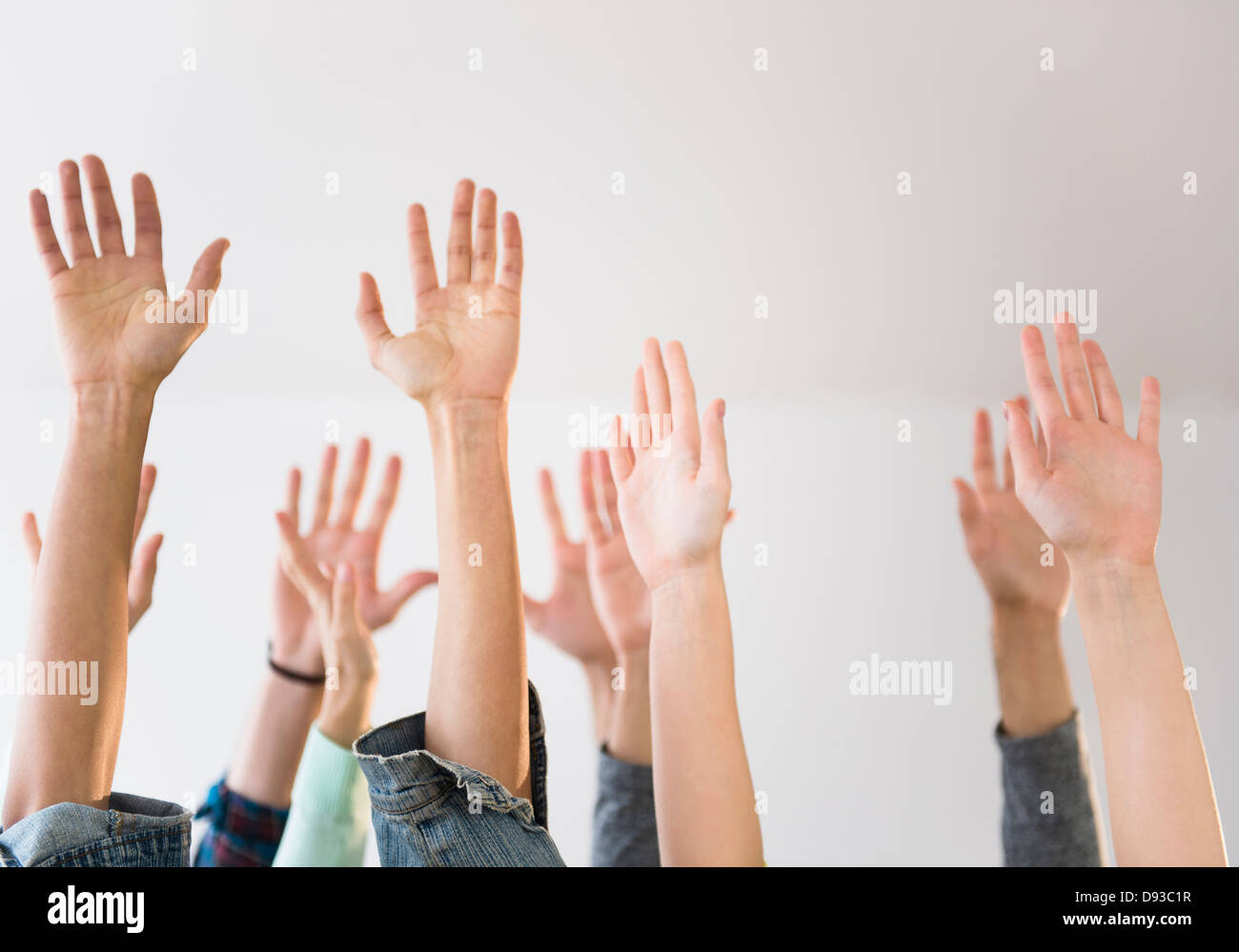 People's hands raised in air Stock Photo