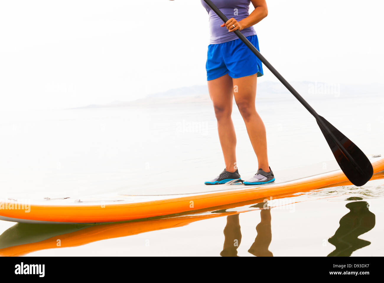 Filipino woman riding paddle board Stock Photo