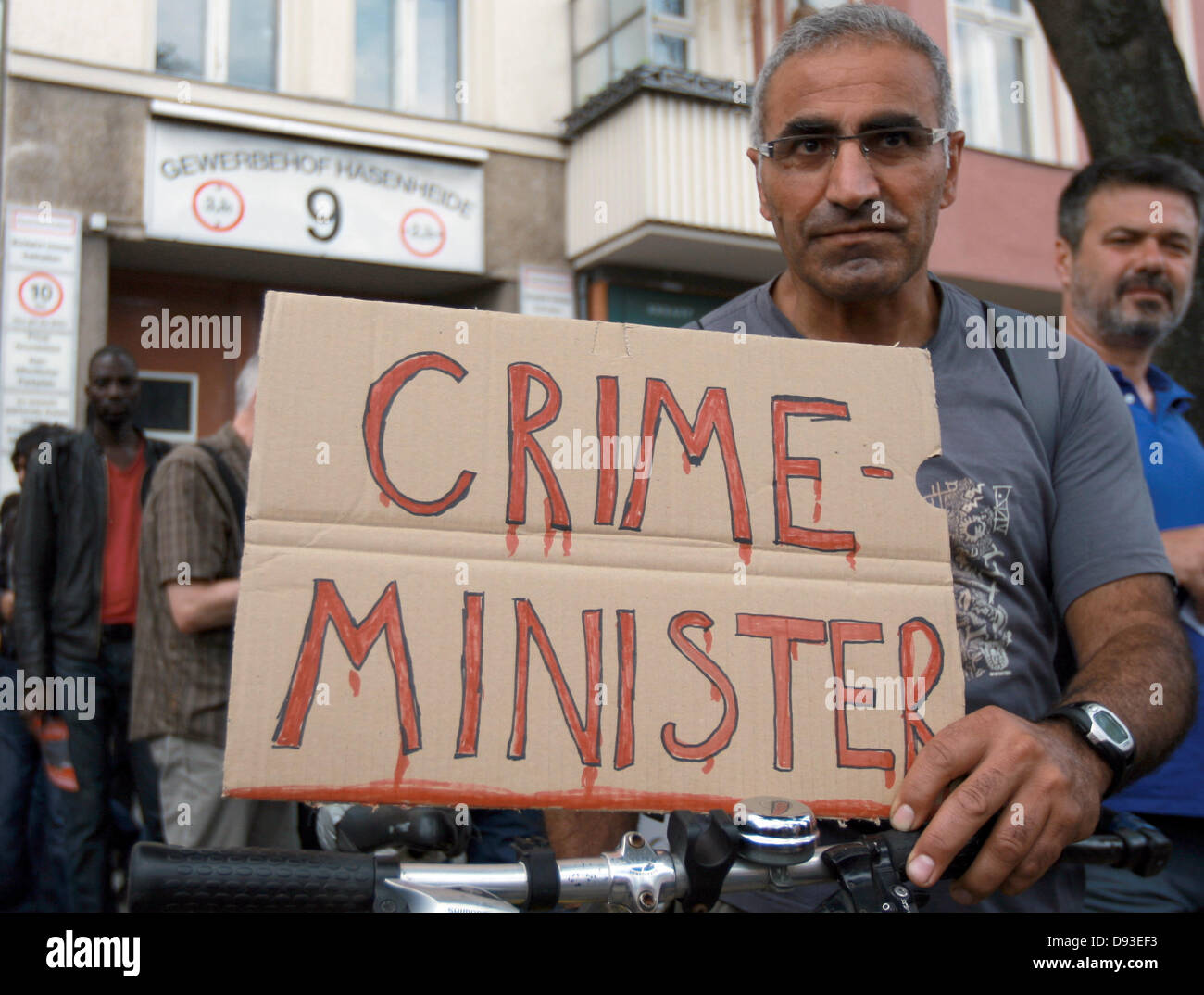 A female demonstrator holds up a placard which reads 'Crime-Minister, as part of a solidarity protest in light of the recent violence against activists in Turkey in Berlin, Germany, 9 June 2013. The protest is directed against the recent police violence against activists in Turkey who have staged protest against the politics of the Turkish President Erdogan. Photo: Joanna Scheffel Stock Photo