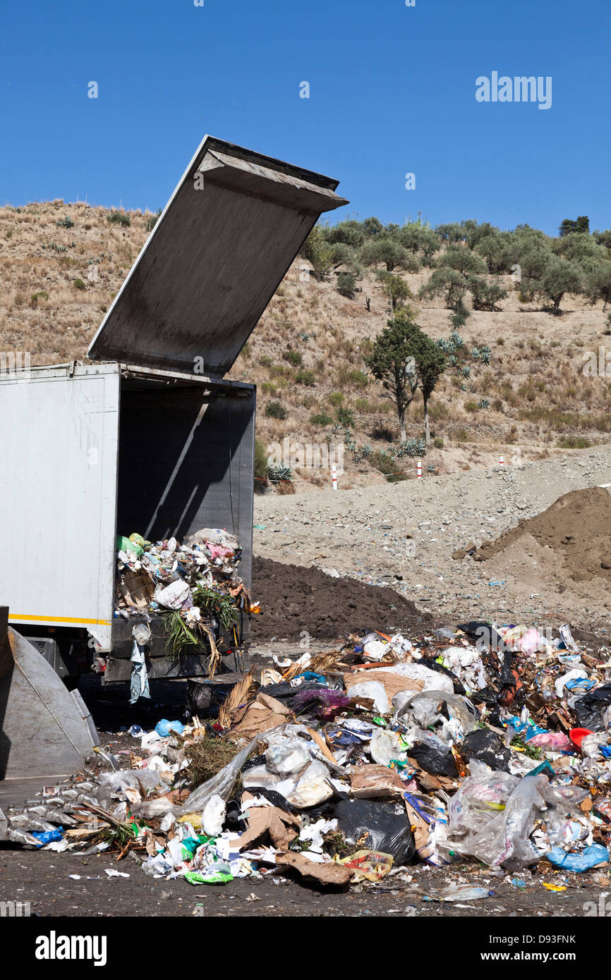 Truck dumping refuse into landfill Stock Photo