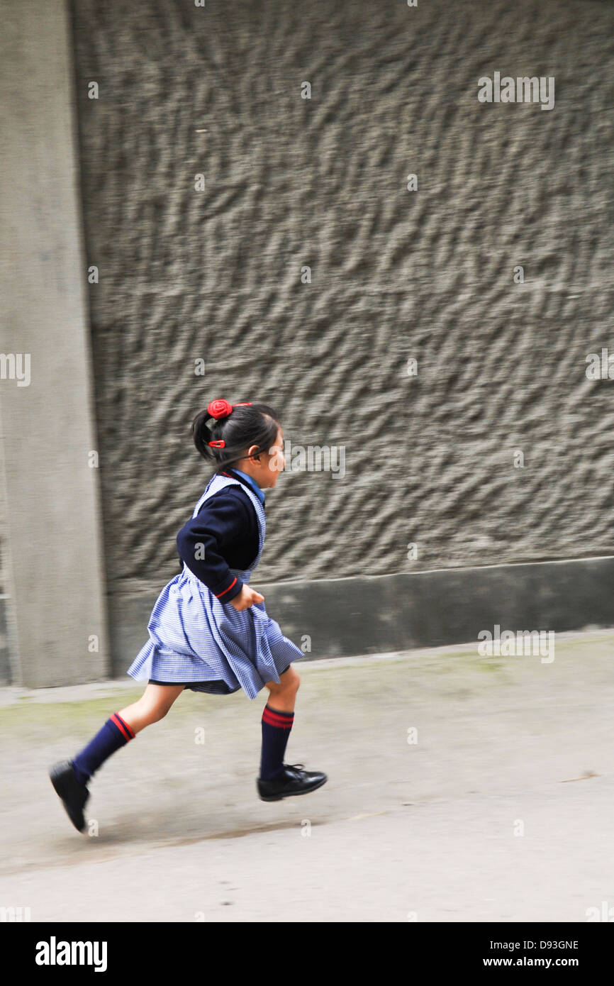 Young girl in uniform on the way to school Darjeeling, West Bengal, India Stock Photo