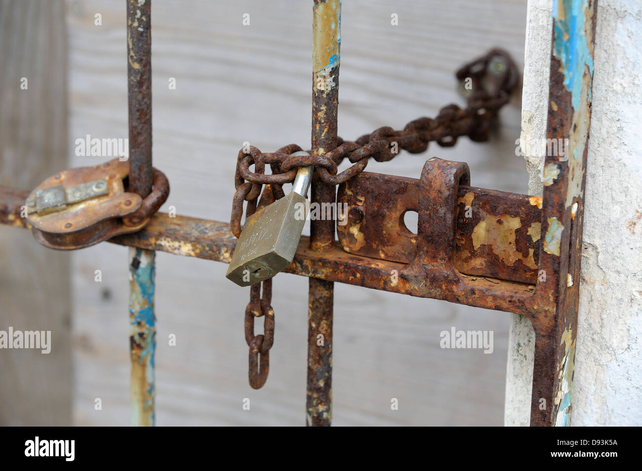 rusty locks on a gated entrance Stock Photo