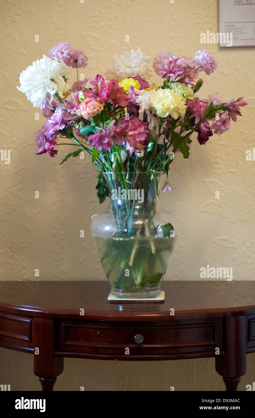 A vase of flowers on a hall table Stock Photo Alamy