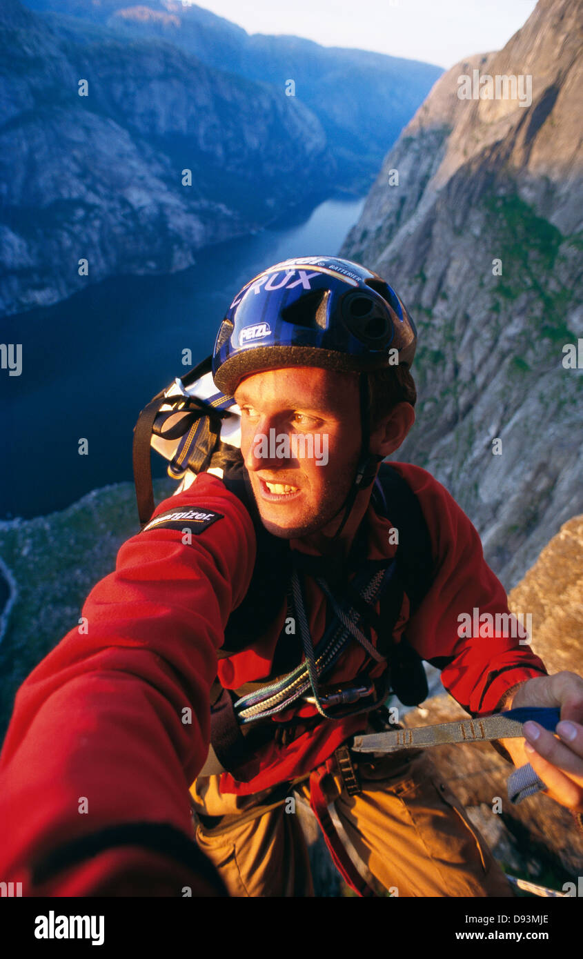 Man climbing on rock Stock Photo - Alamy