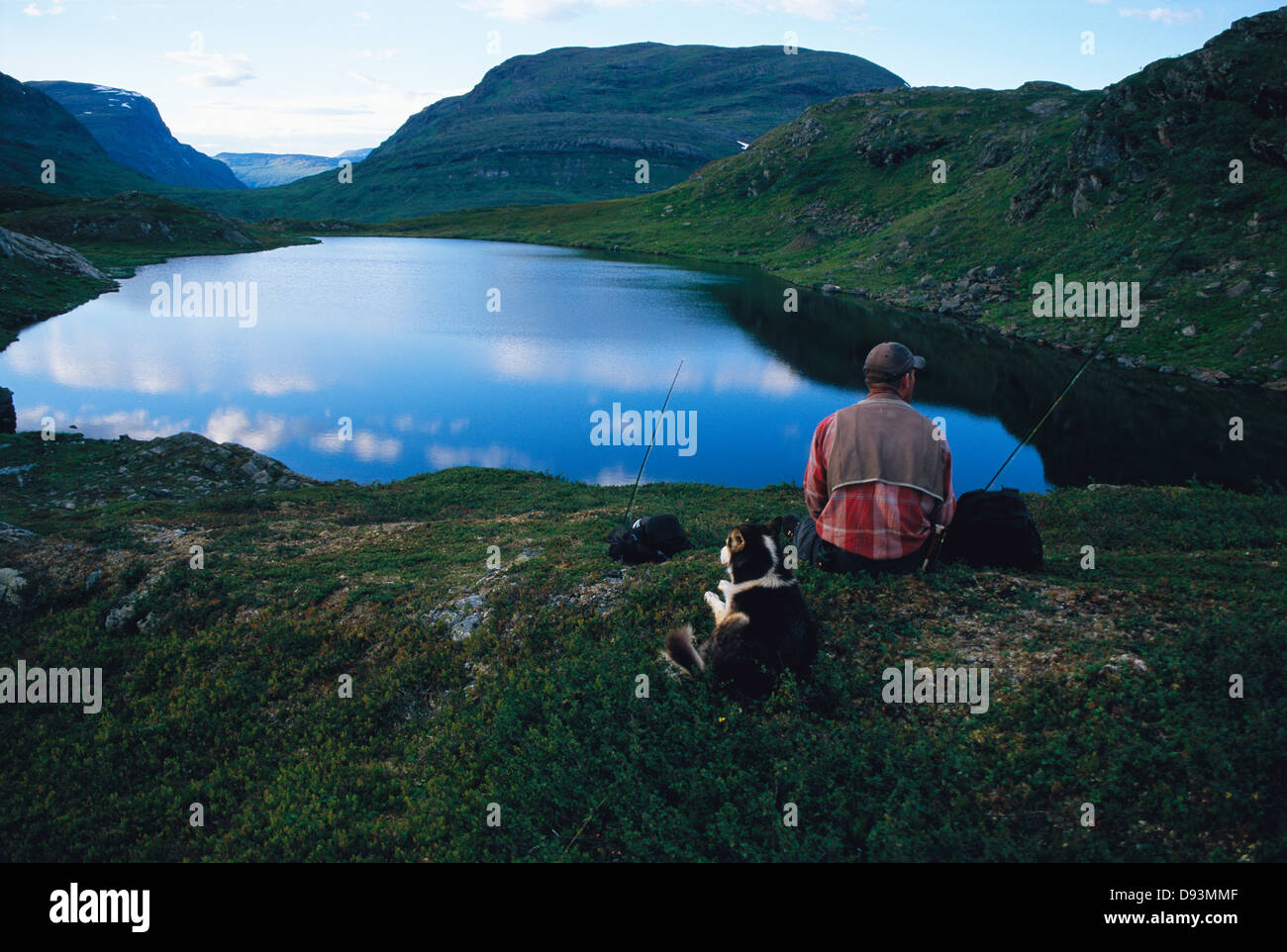 Man sitting near lake dog hi-res stock photography and images - Alamy