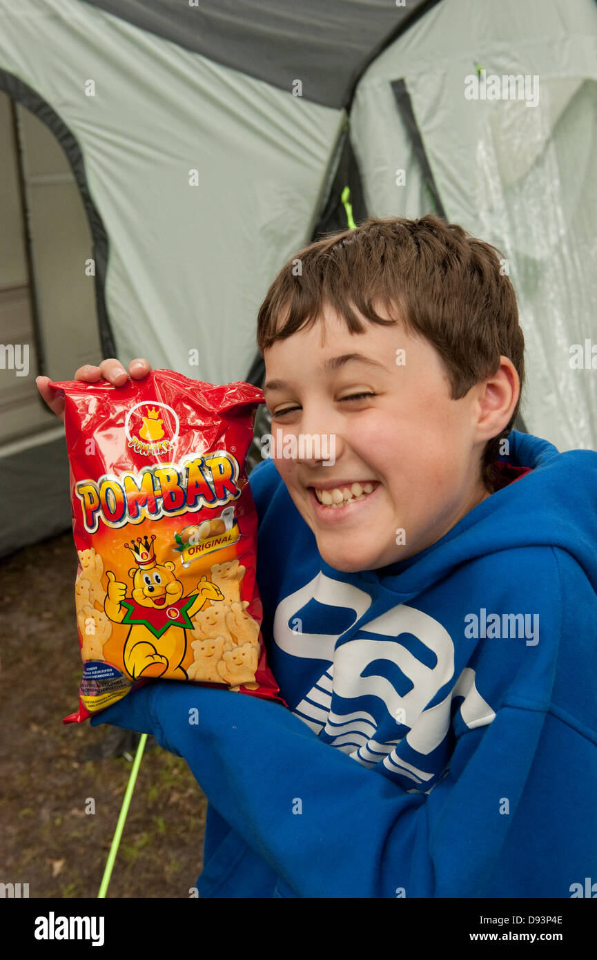 Young Boy happy with Pom Bear Pom-Bar Crisps Snack Chips FULLY MODEL RELEASED Stock Photo