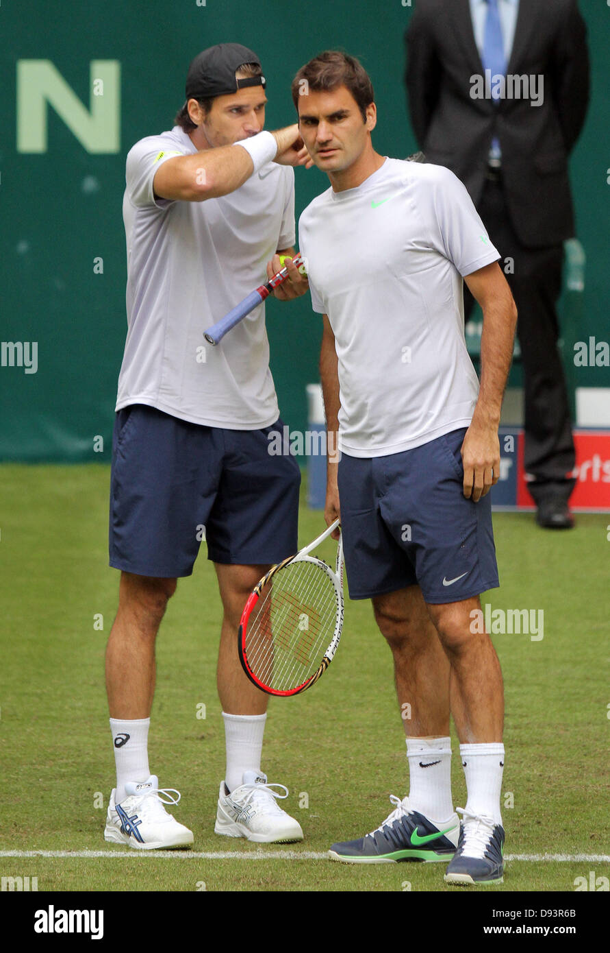 Halle/North Rhine-Westphalia, Germany. 10th June, 2013. Swiss tennis player  Roger Federer (R) listens to his doubles partner Tommy Haas from Germany  during the ATP tournament in Halle/North Rhine-Westphalia, Germany, 10 June  2013.