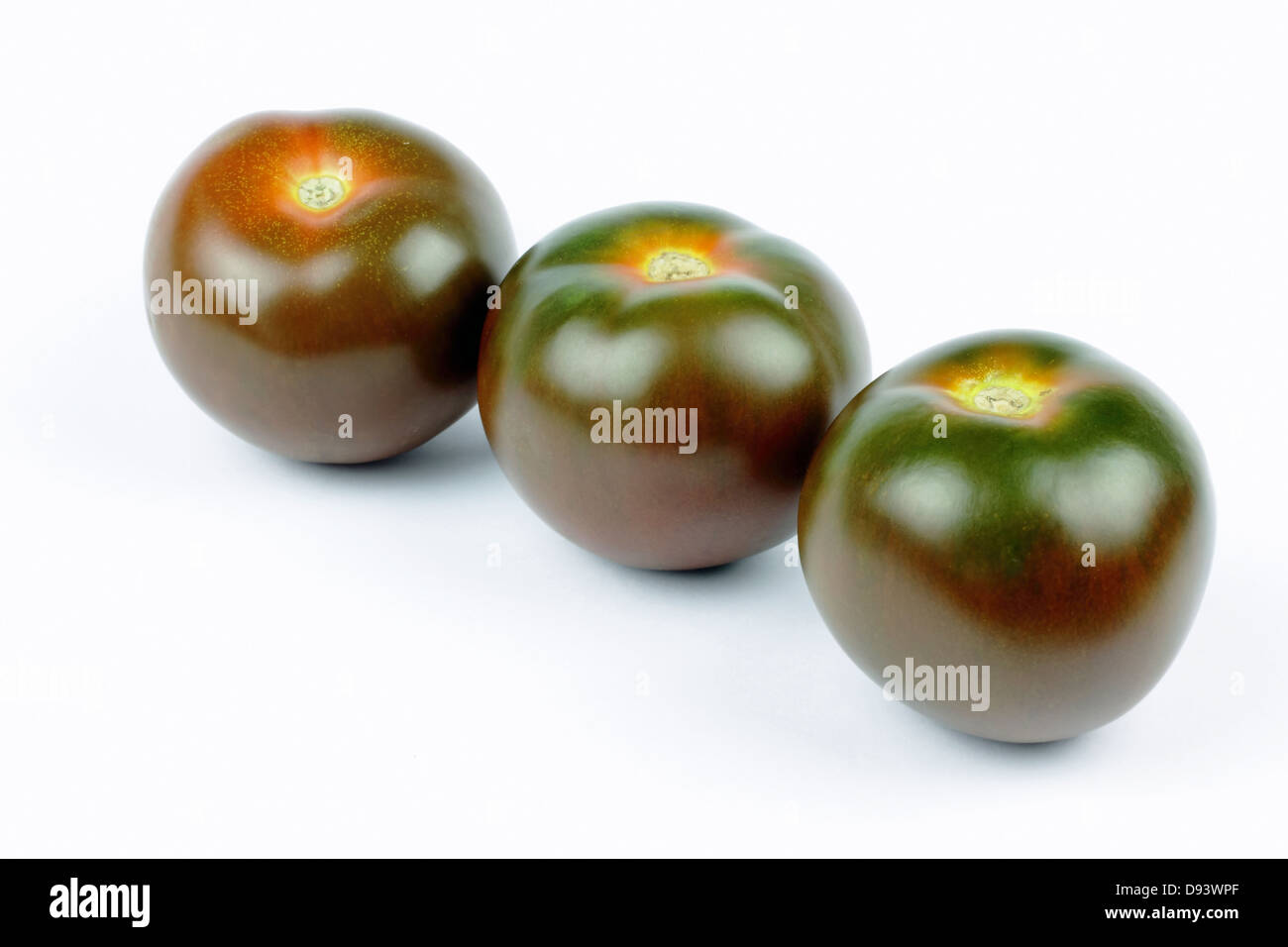 kumato tomatoes on the white background Stock Photo Alamy
