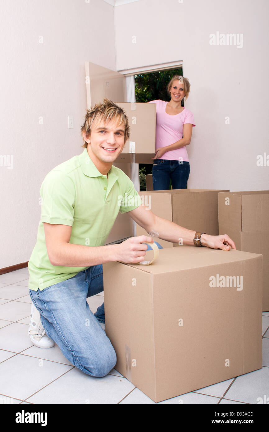 happy young couple moving to new home Stock Photo - Alamy