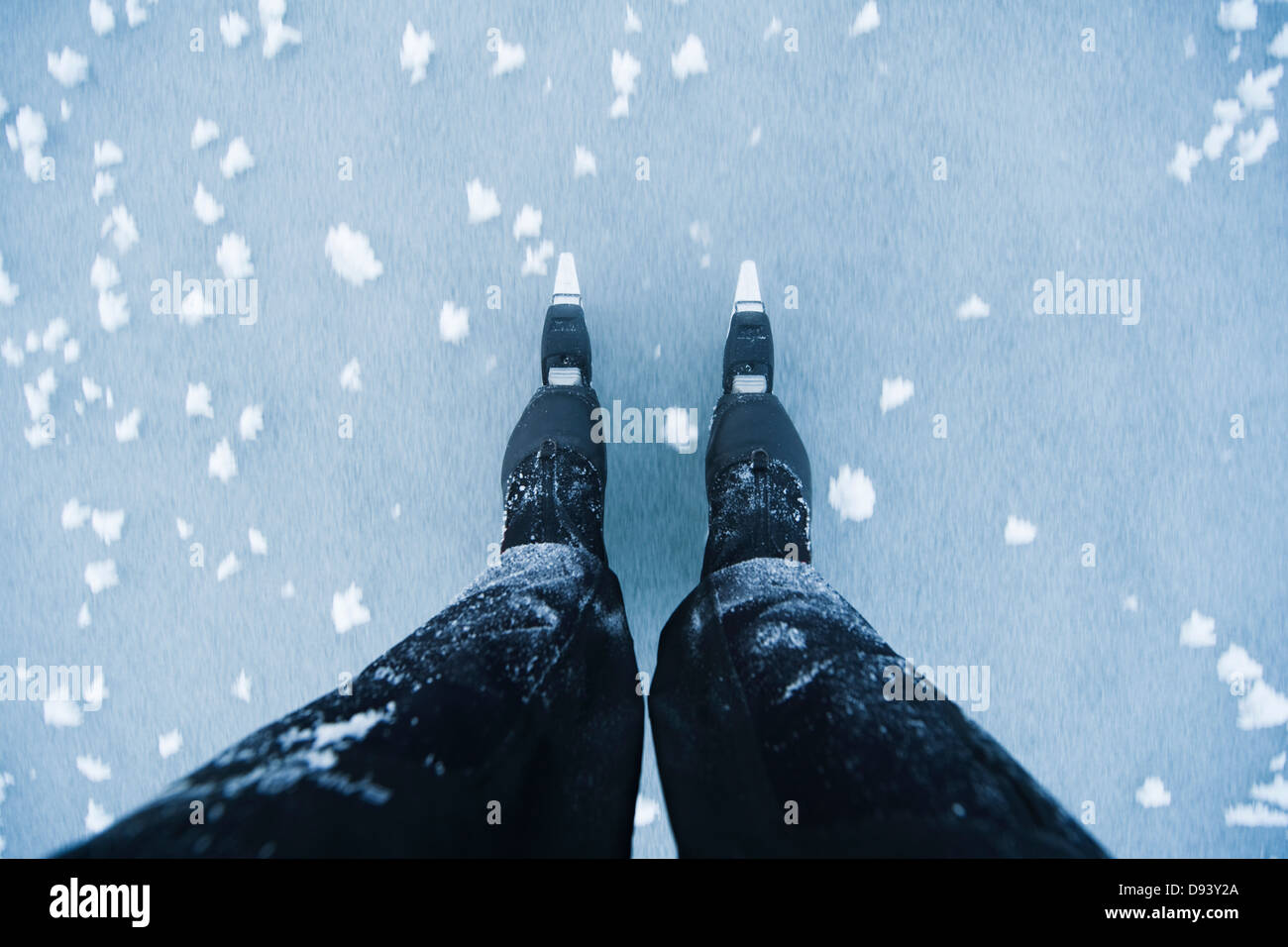 Human legs wearing ice-skates Stock Photo