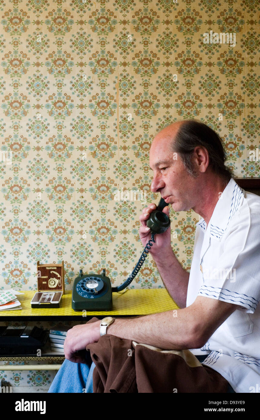 man using traditional land line telephone in his home Stock Photo