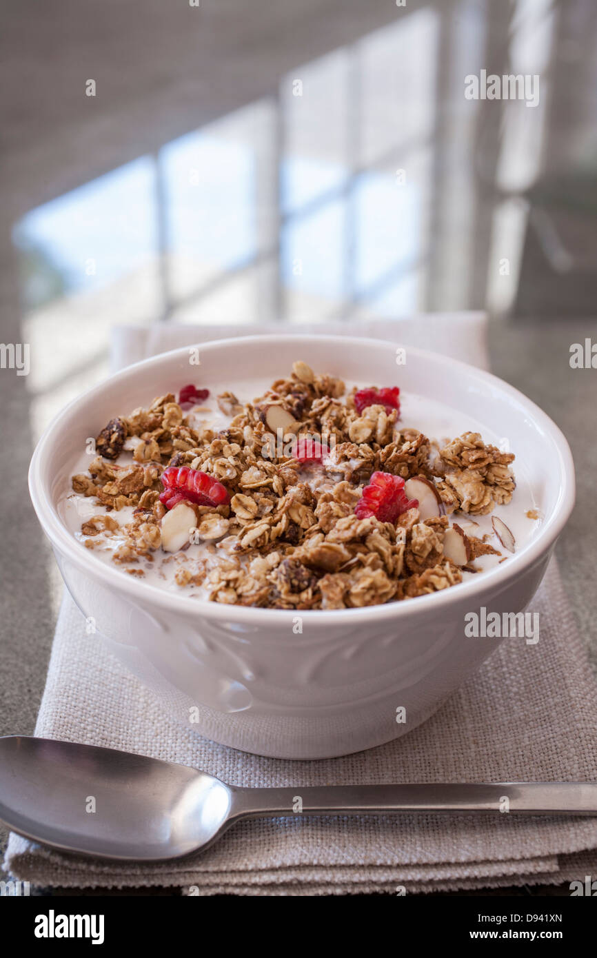 whole grain cereal bowl spoon raspberries Stock Photo