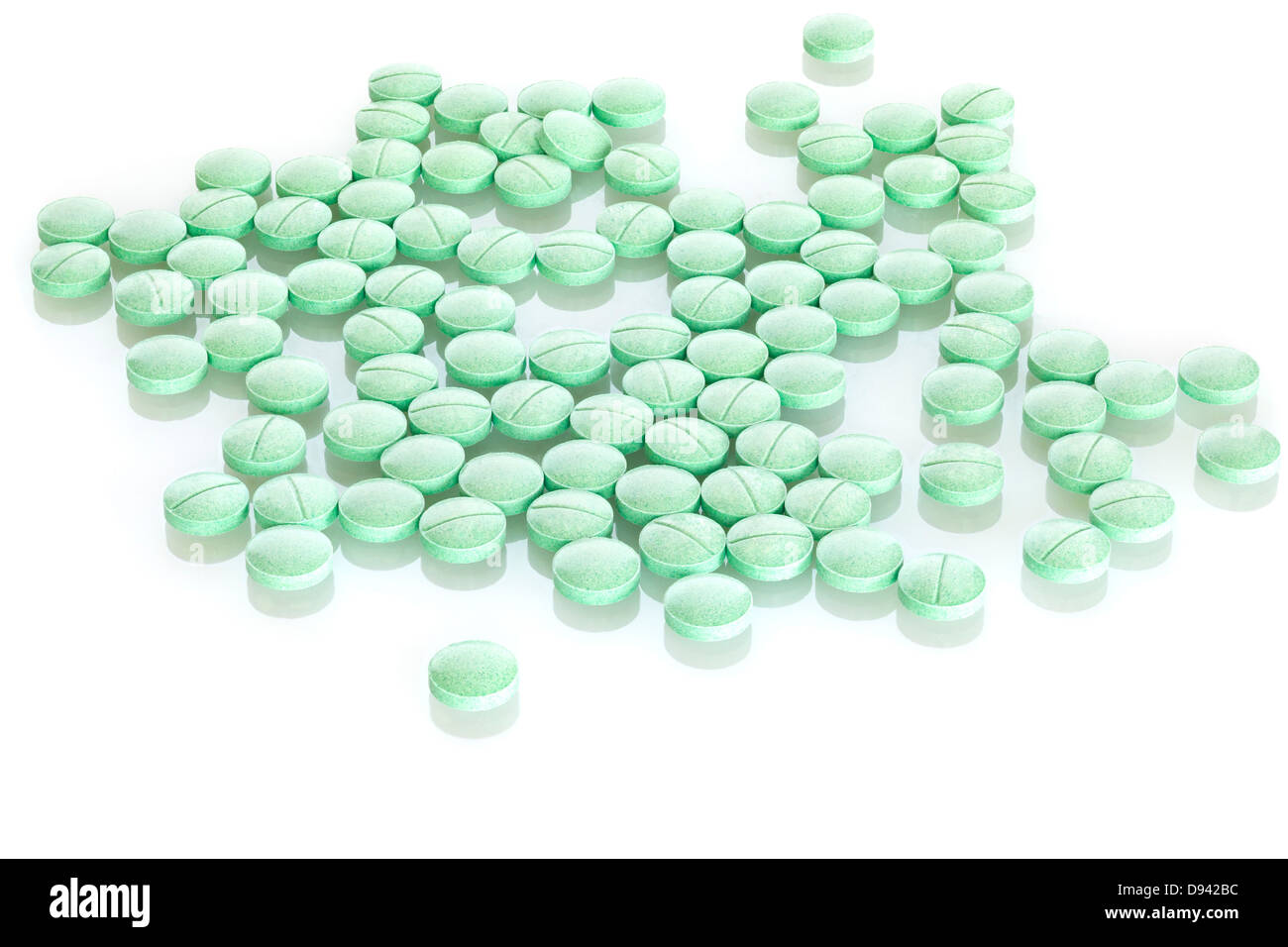 Tablets on White Background - green prescription pills on a white background. Front to back focus. Stock Photo