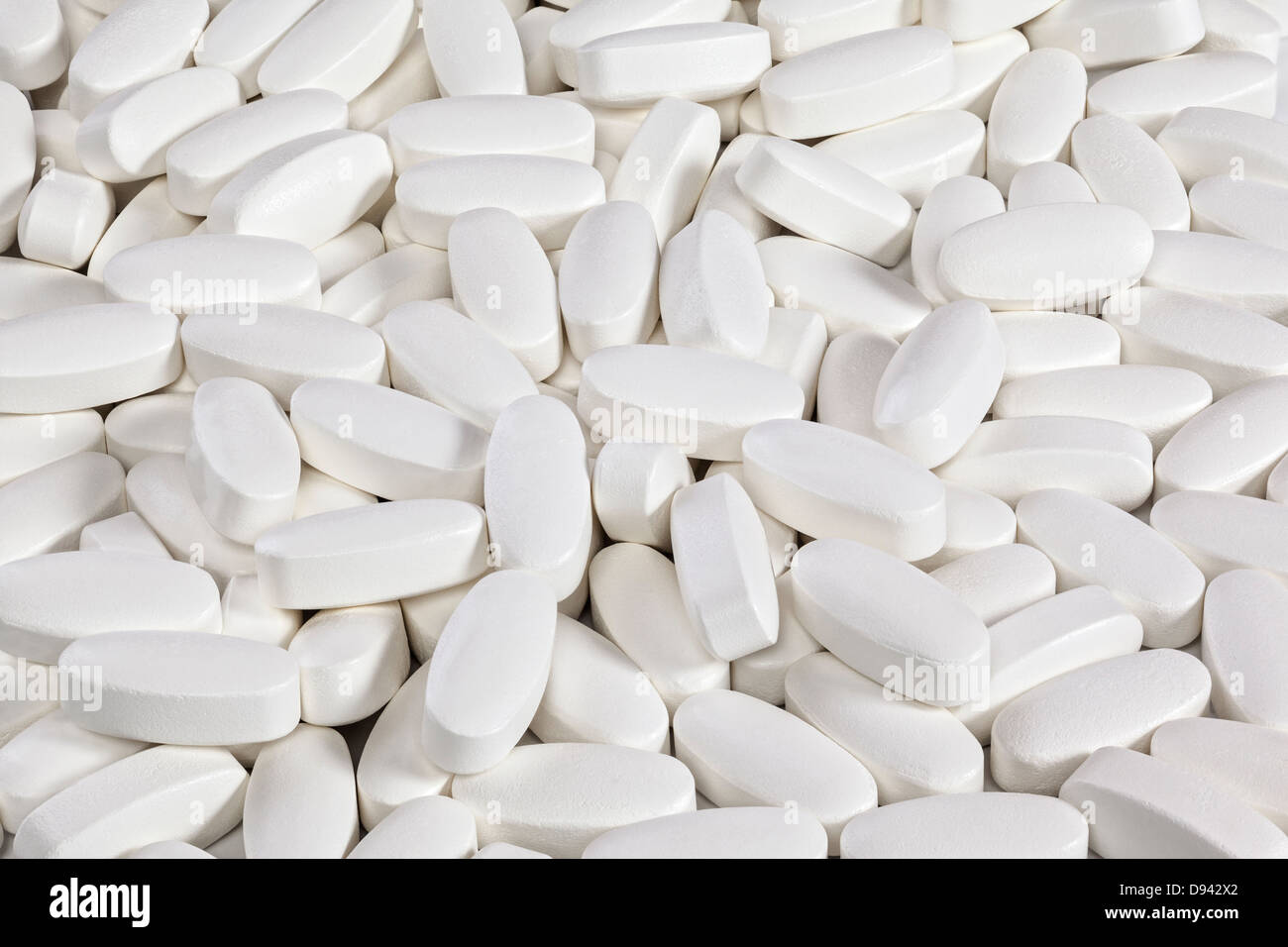 White Tablets Background - background of white pills or tablets, front to back focus. Stock Photo