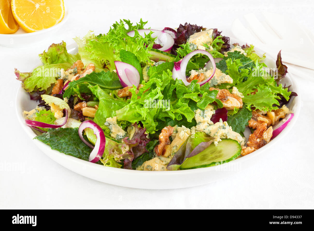 Salad with walnuts and blue cheese, cucumber and onion, and lettuce. Stock Photo