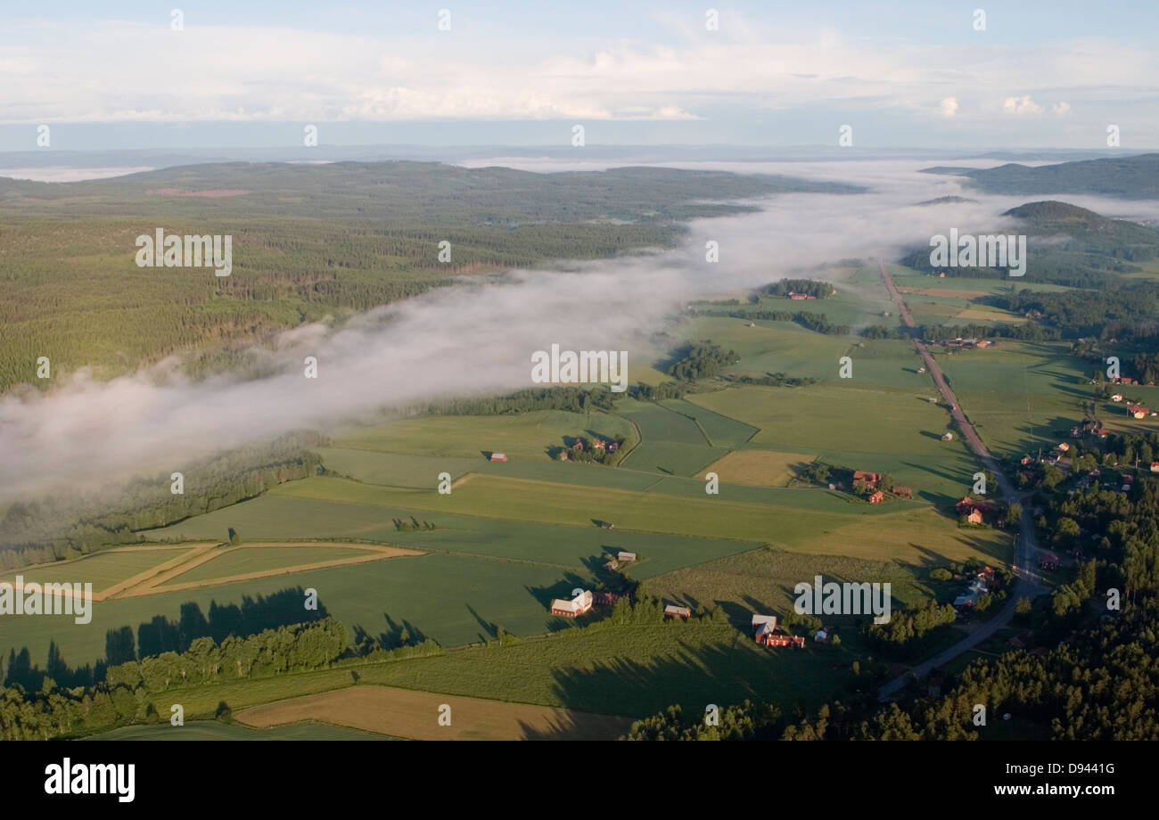 Morning fog over houses and fields, Sweden. Stock Photo