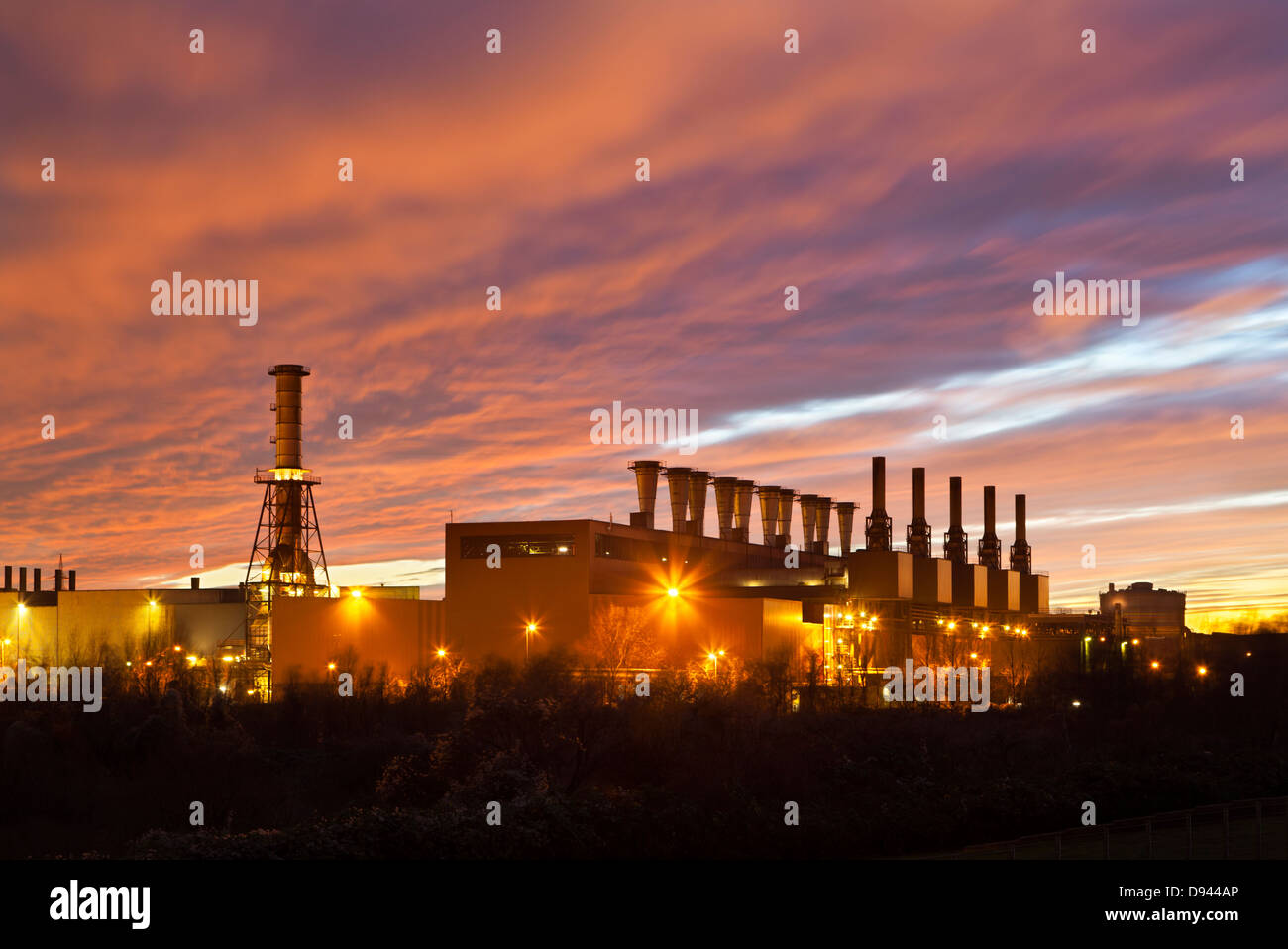 Steel plant with a evening sky looking like it is on fire. Stock Photo