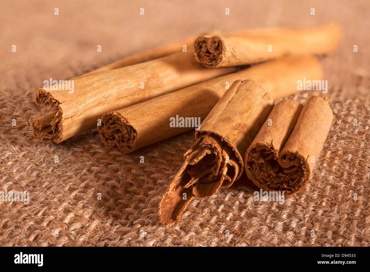 Cinnamon quills on hessian or sack cloth. This tasy and popular spice is widely used in baking and also in curries. It is... Stock Photo